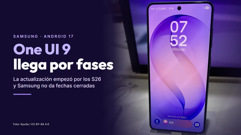 Un Samsung Galaxy S26 encendido en el expositor de una tienda, junto al texto «One UI 9 llega por fases»